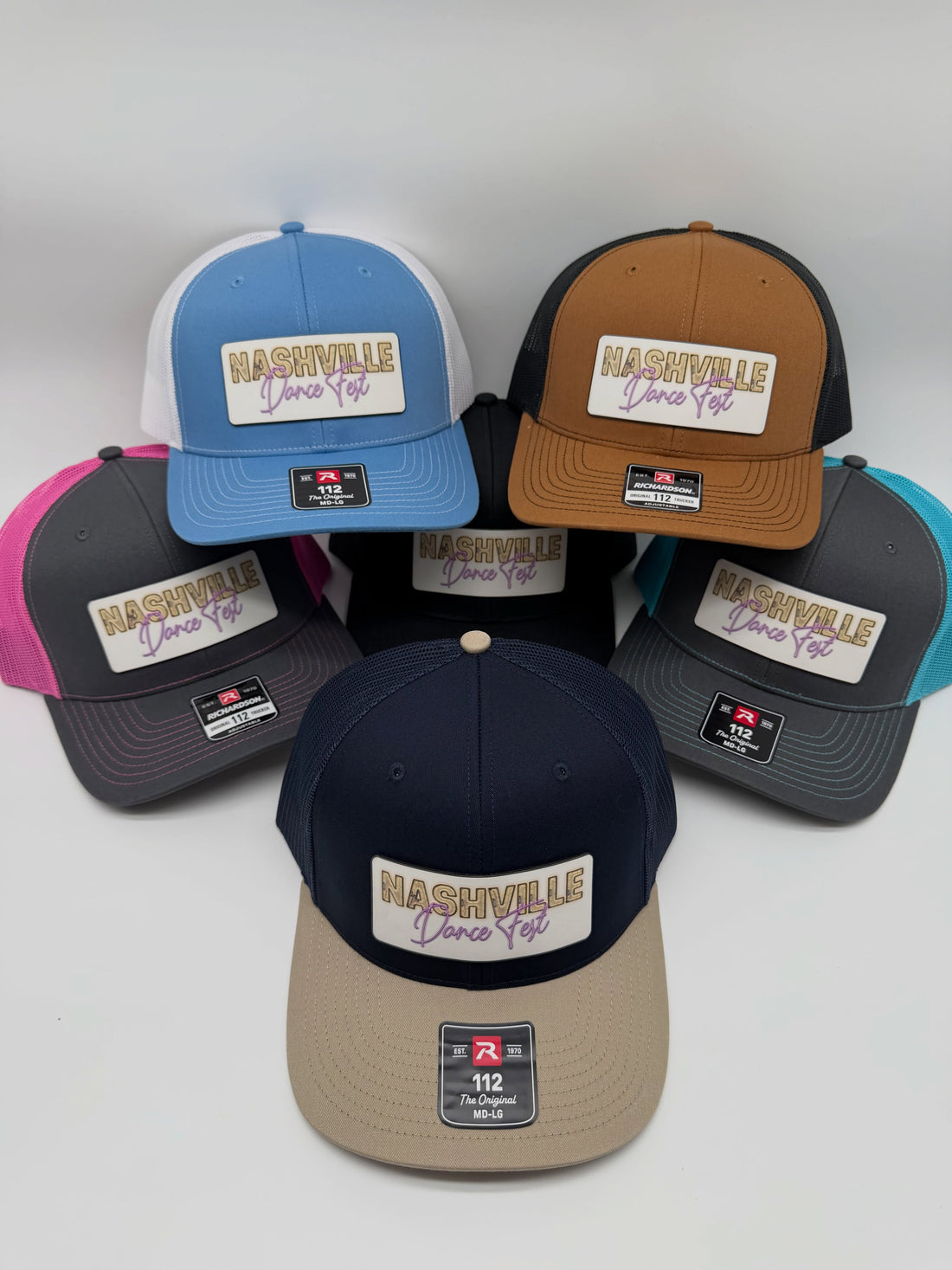 A group of custom Nashville patch hats in different crown, brim and mesh colors
