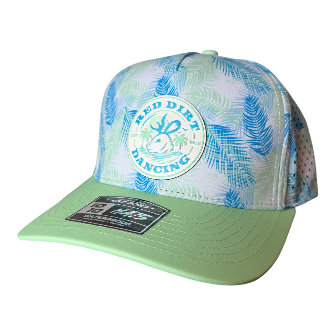 Green and blue tropical performance hat with a color matched Red Dirt Dancing circular logo patch
